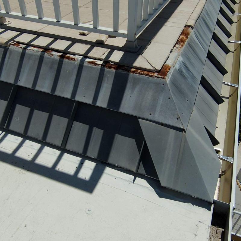 Metal roof flashing with rust near balcony railing Metal roof flashing with rust near balcony railing