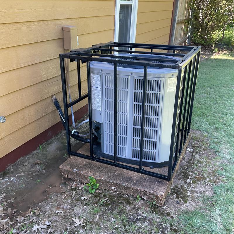 Condenser unit maintenance with protective cage installed Condenser unit maintenance with protective cage installed