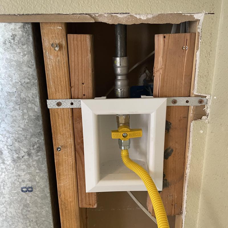 Gas valve box with yellow flexible gas line installation