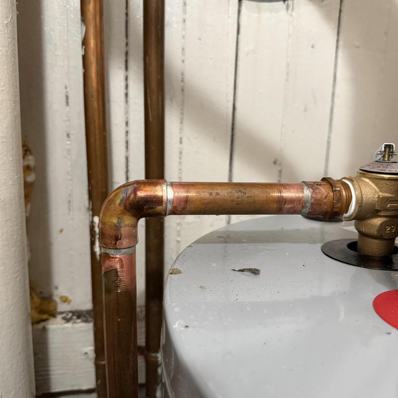 Copper water line with 90-degree fitting on water heater Copper water line with 90-degree fitting on water heater