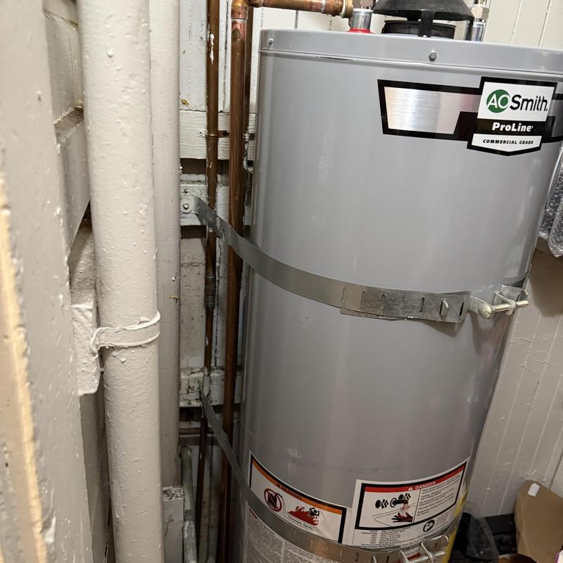 Water heater with copper piping and metal straps Water heater with copper piping and metal straps