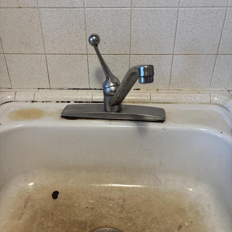 Kitchen faucet and sink with discoloration and grime Kitchen faucet and sink with discoloration and grime