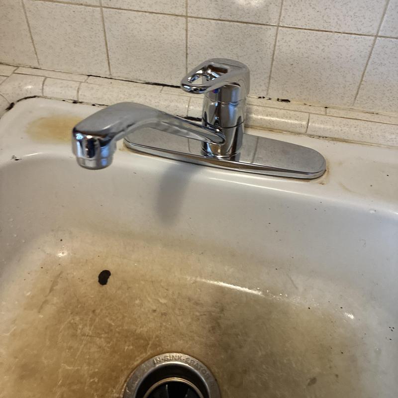 Kitchen faucet and sink with water stains and grime Kitchen faucet and sink with water stains and grime