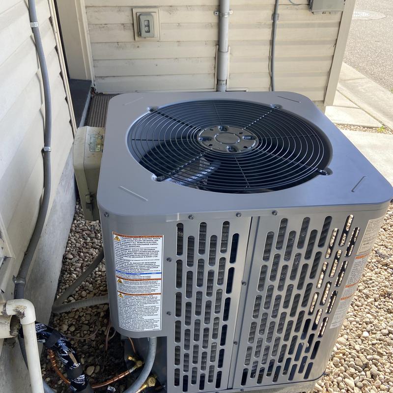 2 ton condenser unit installed beside house exterior