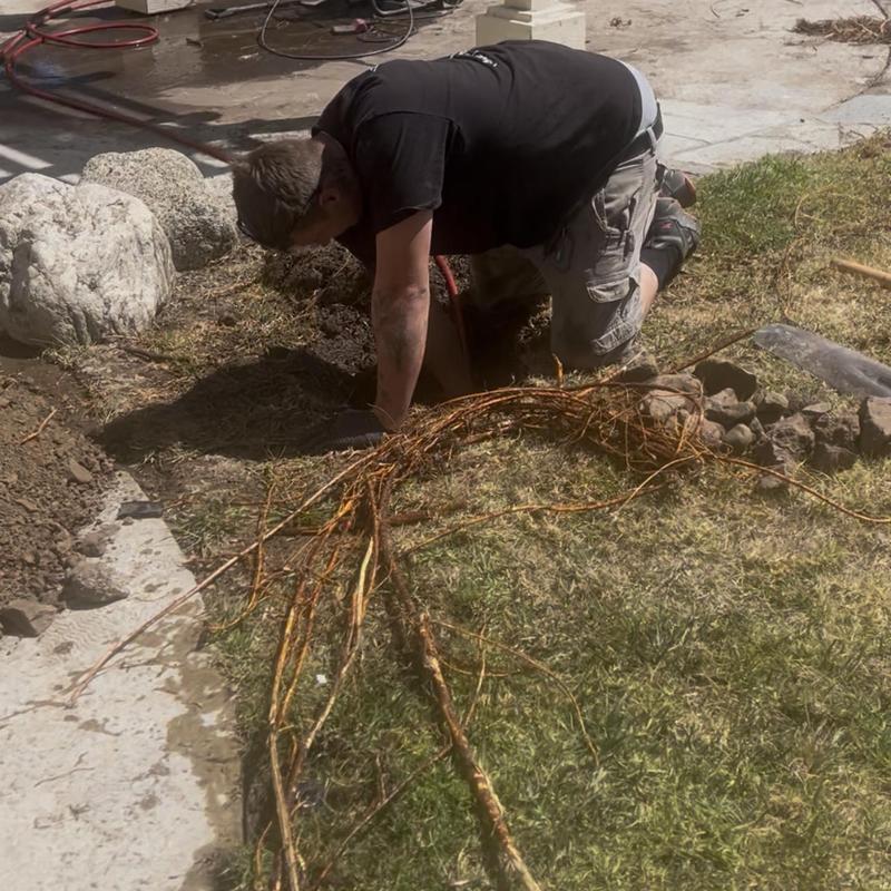 Storm drain root removal with jetter machine outdoors