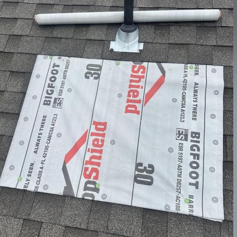 Synthetic underlayment patch on roof near vent pipe