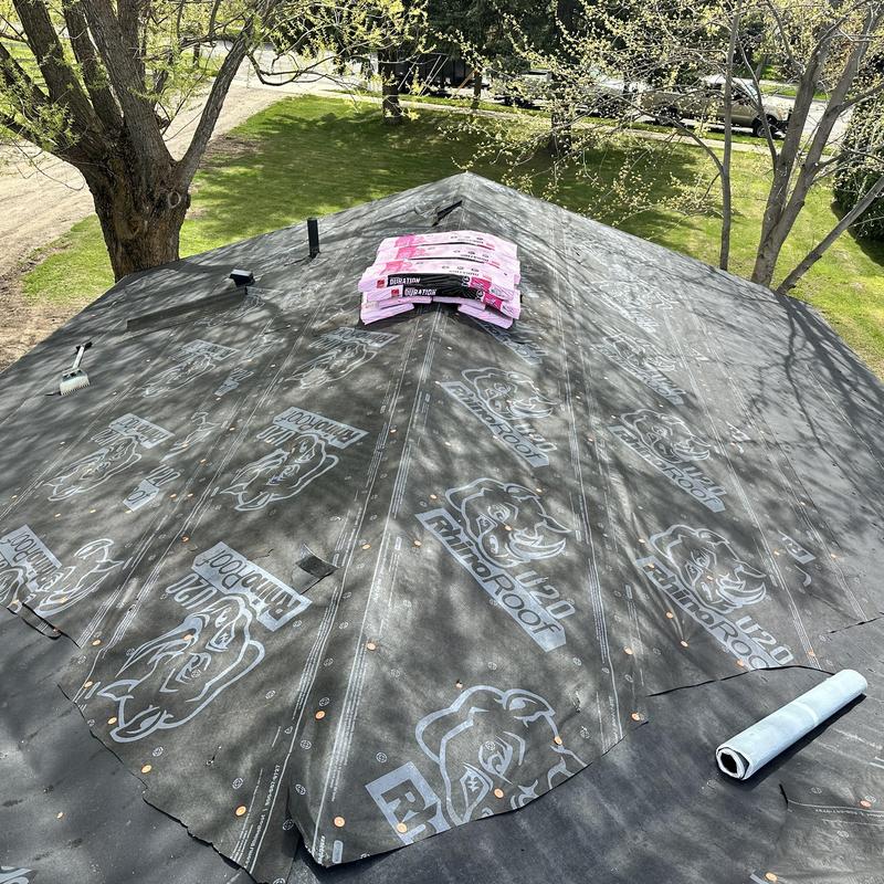 Roof underlayment installation with roofing materials on top Roof underlayment installation with roofing materials on top