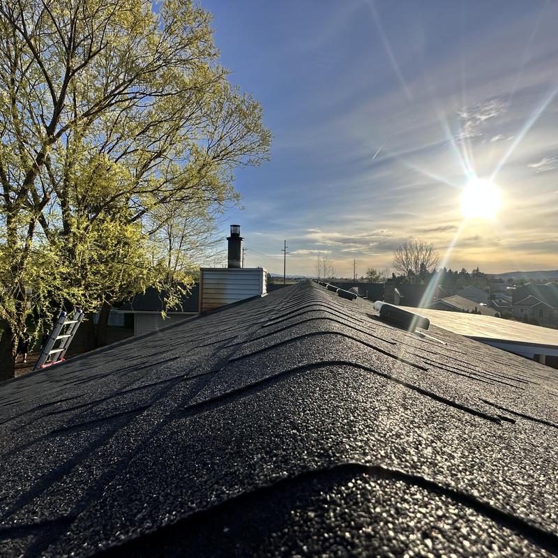 Asphalt shingle roof replacement with sunset background Asphalt shingle roof replacement with sunset background