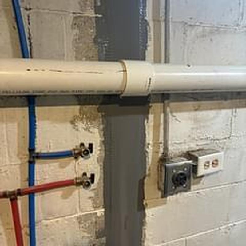 3-inch PVC drain line with new coupling in basement