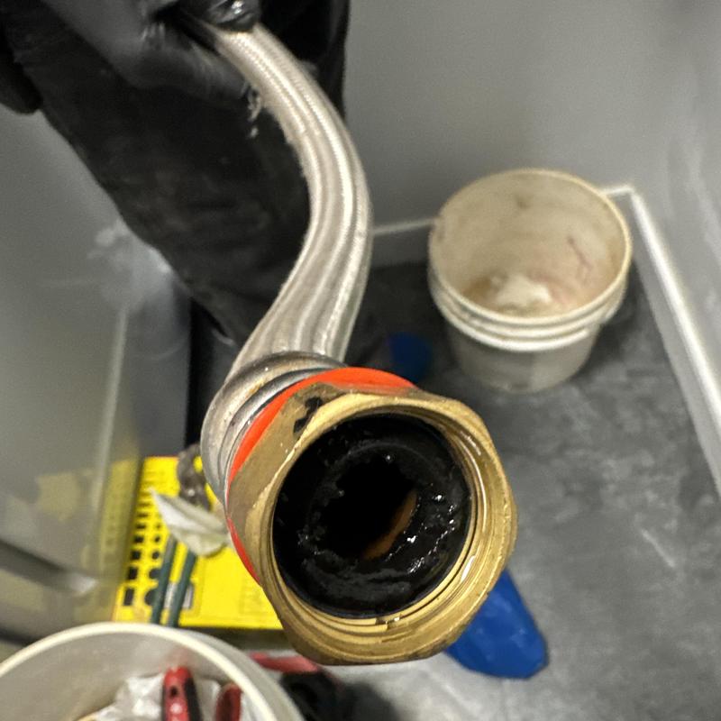 Electric tankless water heater pipe clogged with residue