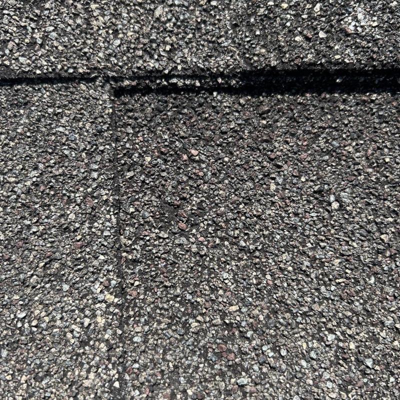 Architectural shingle roofing surface with storm hail damage