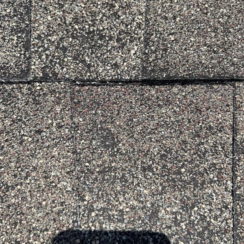 Architectural shingle roof showing hail damage inspection