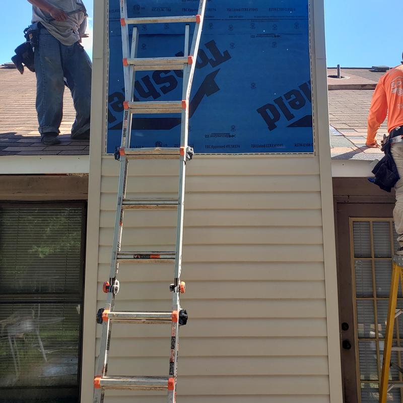 Asphalt shingle roof replacement with wood repair in progress