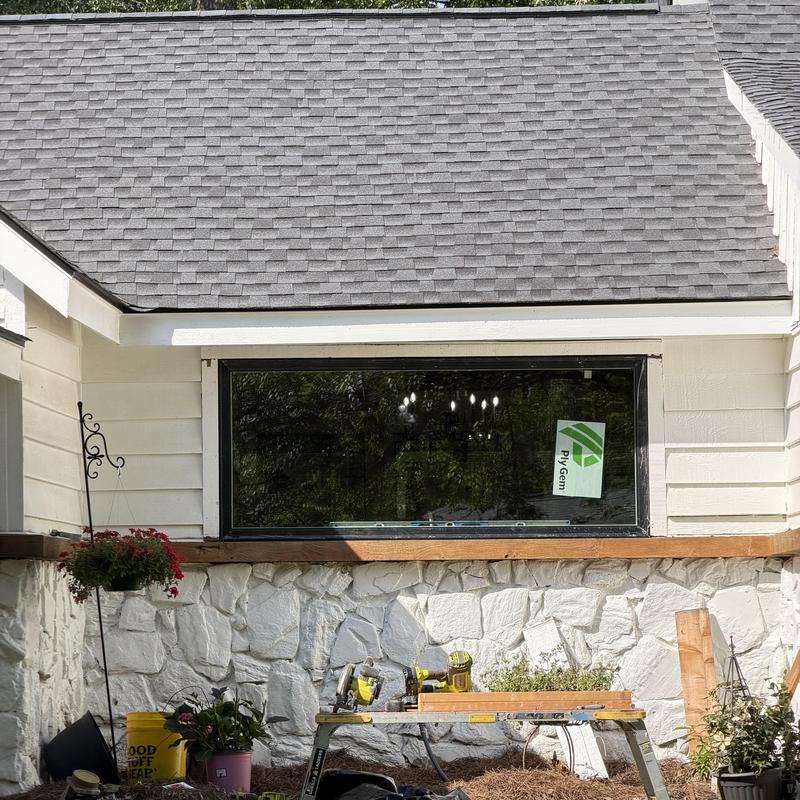 Kitchen sink window installation on stone wall exterior