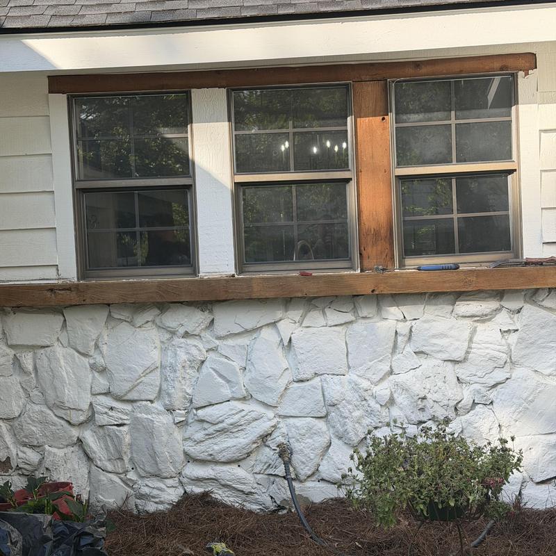 Kitchen sink window installation with wooden trim