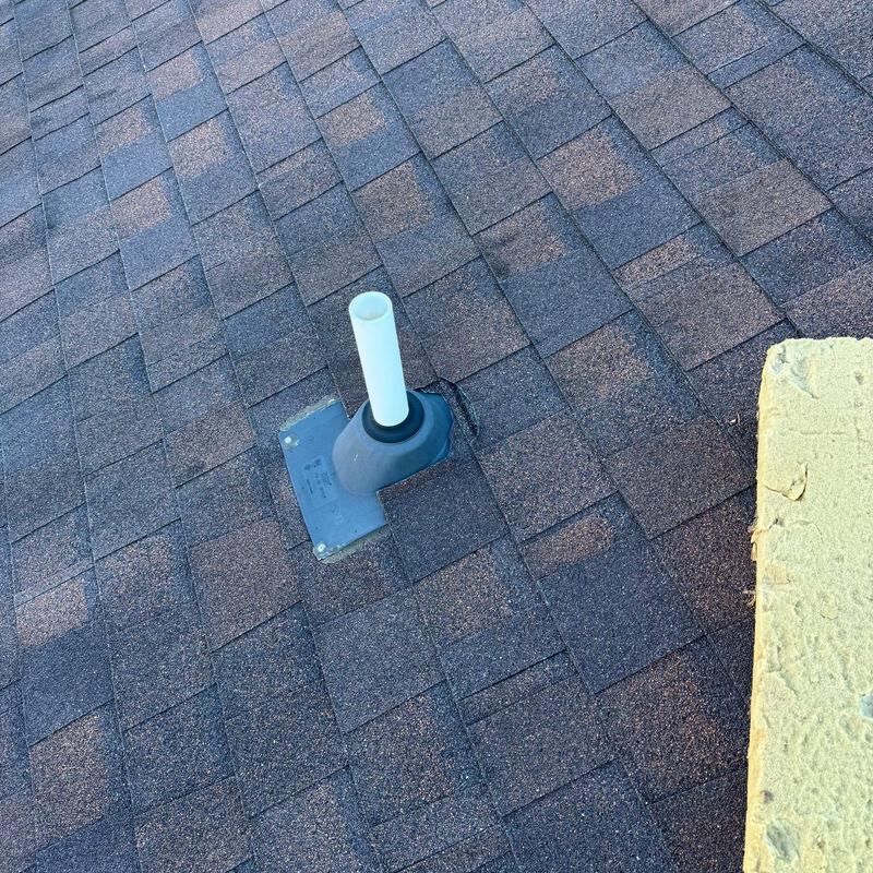 Asphalt shingle roof with pipe flashing sealant