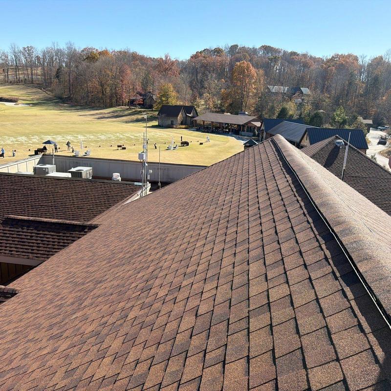 Asphalt shingle roof ridge cap with hail damage inspection