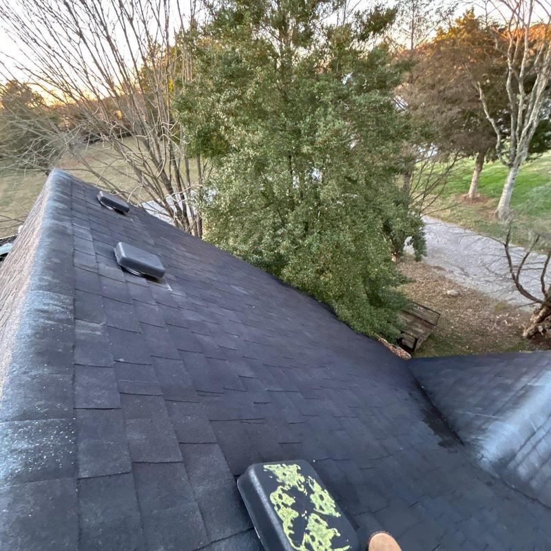 Asphalt shingles with hail damage and ventilation vents