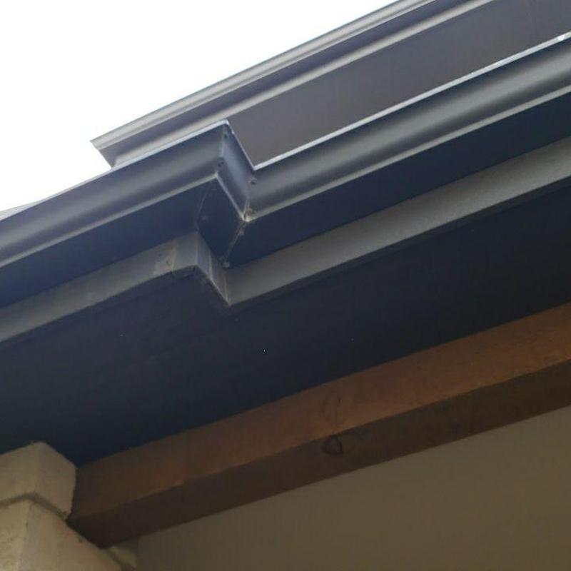 Metal rain gutter corner and roof edge detail Metal rain gutter corner and roof edge detail