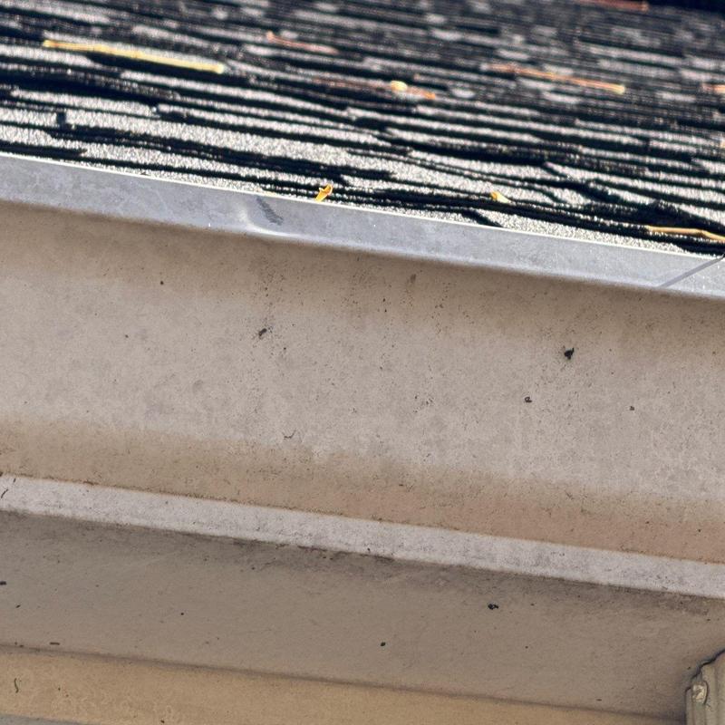 Roof shingles with hail damage and metal flashing