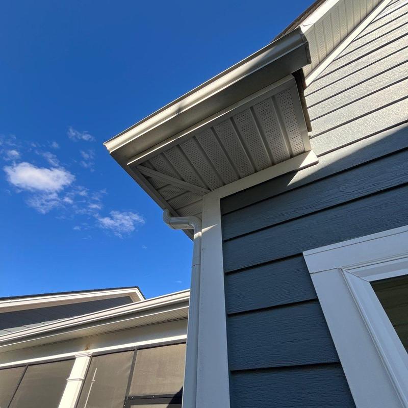 Roof edge and gutter system inspection under blue sky