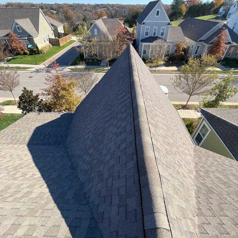 Asphalt shingle roof ridge with hail damage inspection