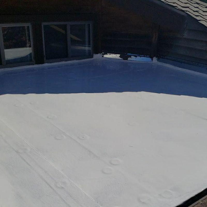 Modified flat roof with white silicone coating applied Modified flat roof with white silicone coating applied