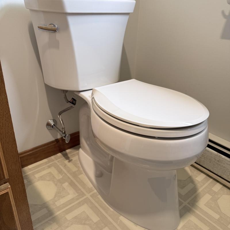 Toilet with replaced flush tank and seat in bathroom Toilet with replaced flush tank and seat in bathroom