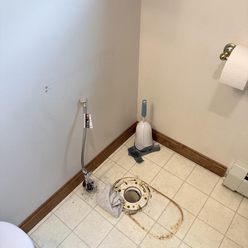Toilet flange and water supply line exposed in bathroom floor Toilet flange and water supply line exposed in bathroom floor