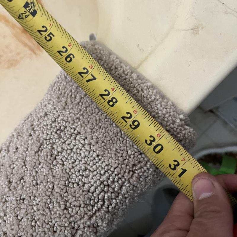 Bathtub edge with measuring tape at 30 inches
