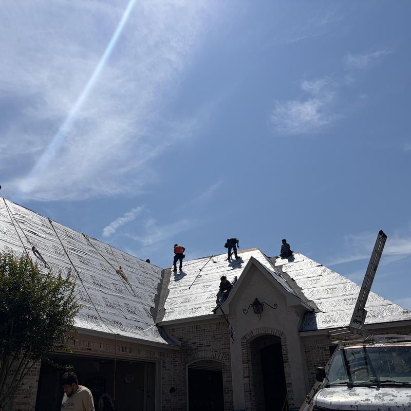 Roof decking with underlayment installation in progress