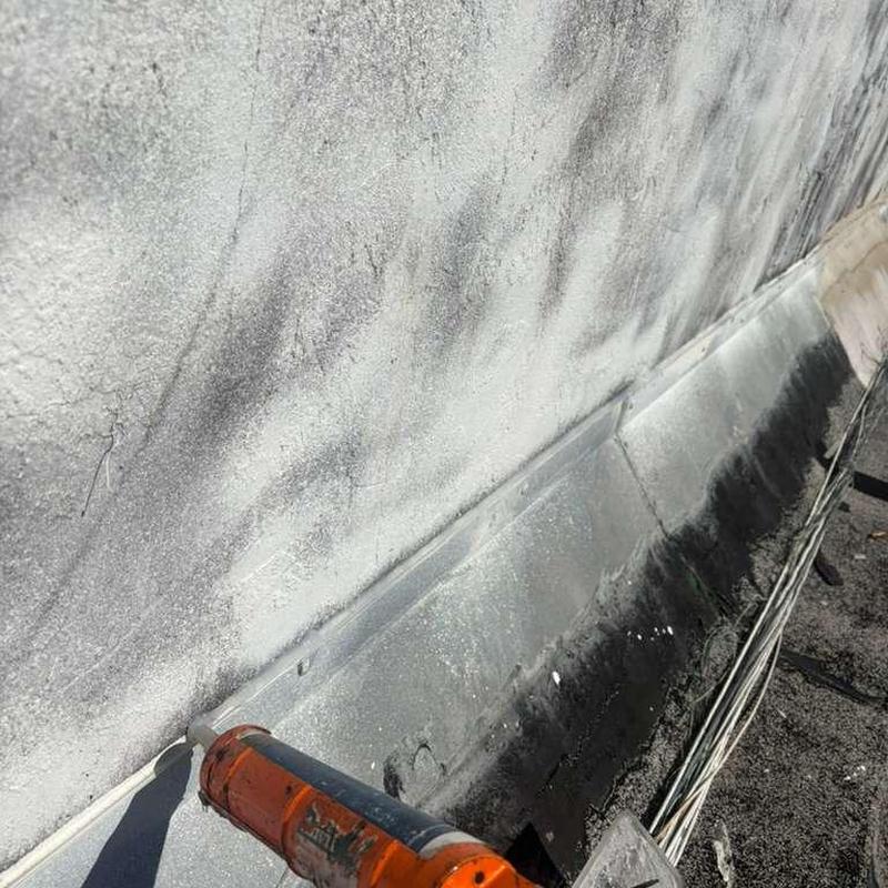 Skylight flashing sealant application on roof edge Skylight flashing sealant application on roof edge