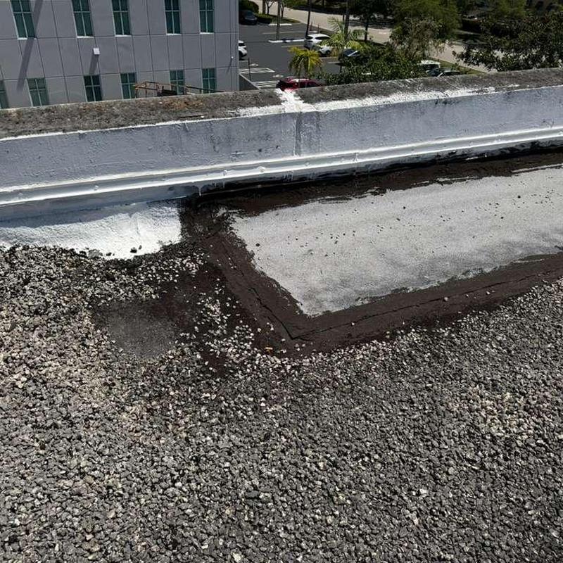 Gravel flat roof patch and membrane repair close-up Gravel flat roof patch and membrane repair close-up
