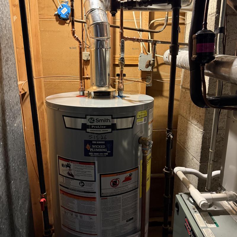 Water heater installation with vent pipe in basement Water heater installation with vent pipe in basement