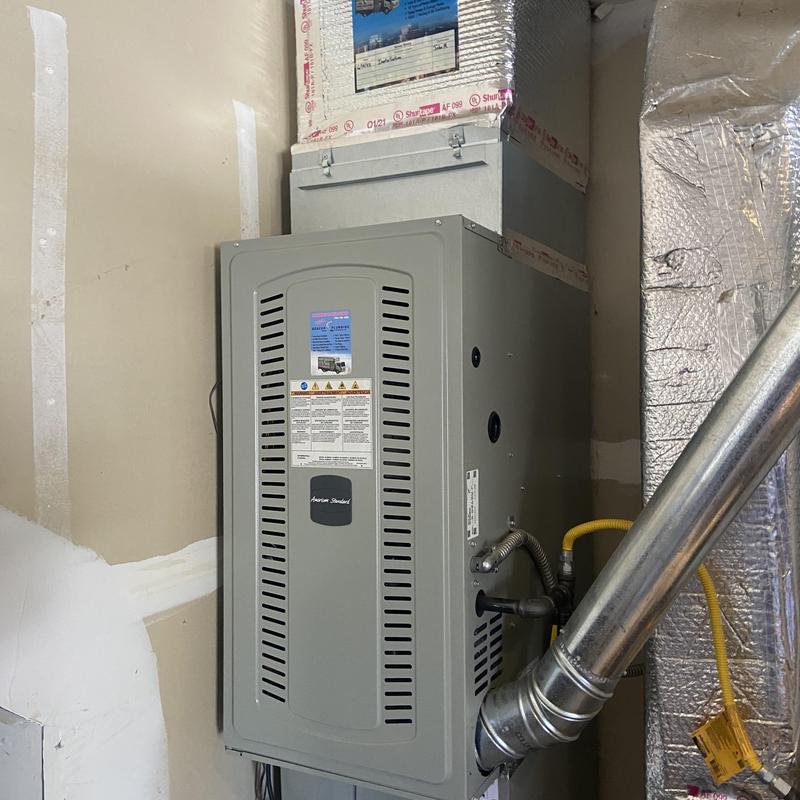 HVAC blower unit with vent pipe in utility room