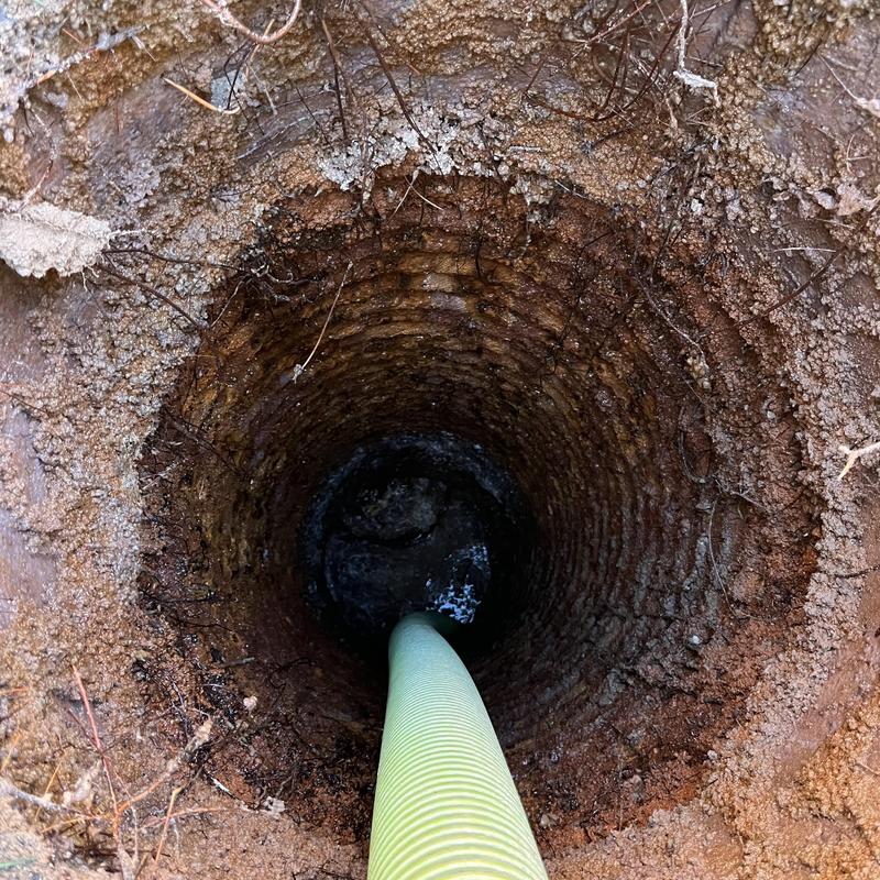 Septic tank pump out with hose inside opening