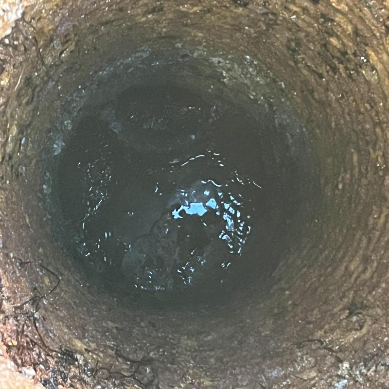 Septic tank interior showing remaining water and solids
