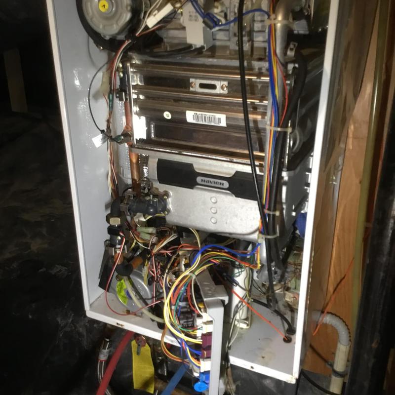 Navien tankless water heater with wiring exposed Navien tankless water heater with wiring exposed