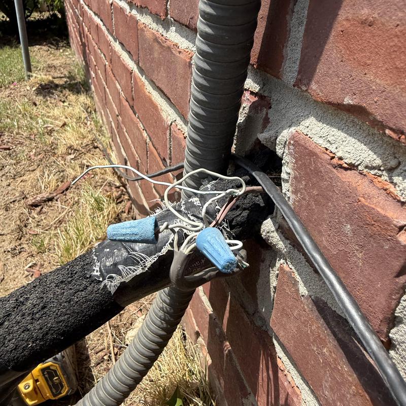 HVAC wiring connections with wire nuts on brick wall HVAC wiring connections with wire nuts on brick wall