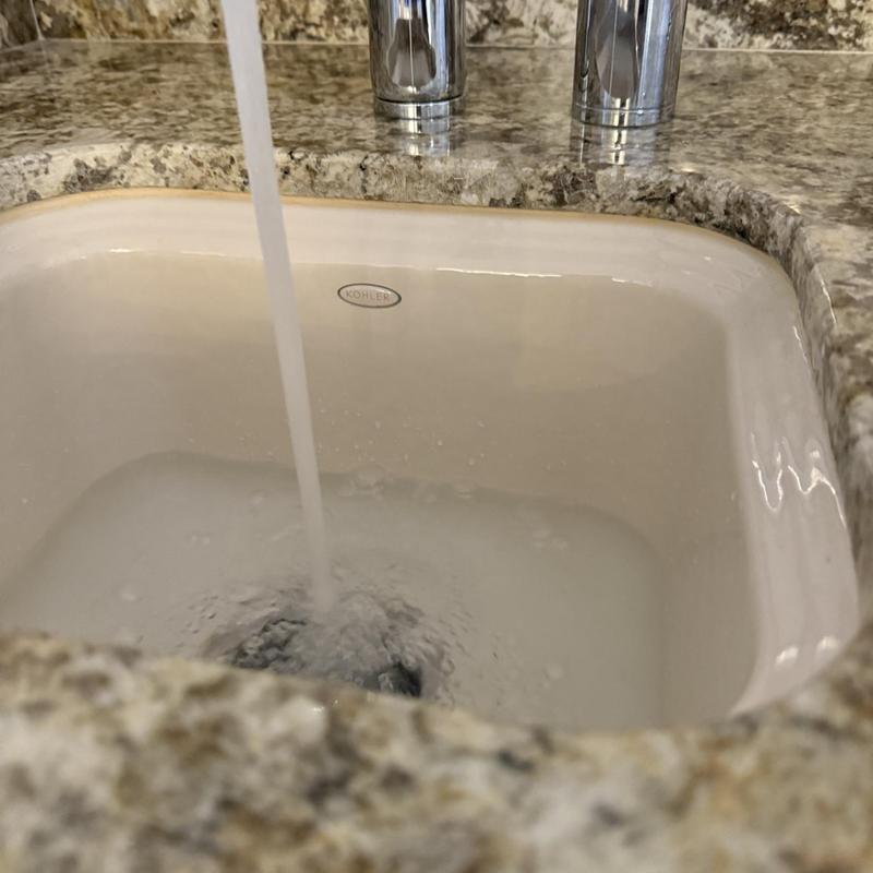 Basket strainer bar sink with running water in granite countertop Basket strainer bar sink with running water in granite countertop