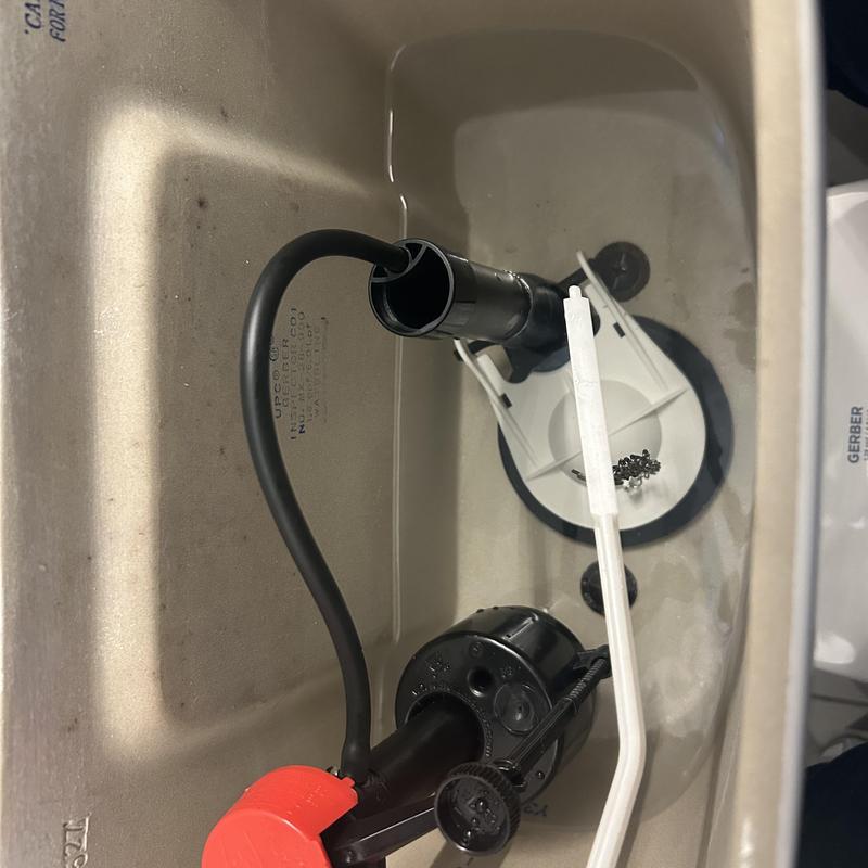 Toilet fill valve and flapper inside tank with water