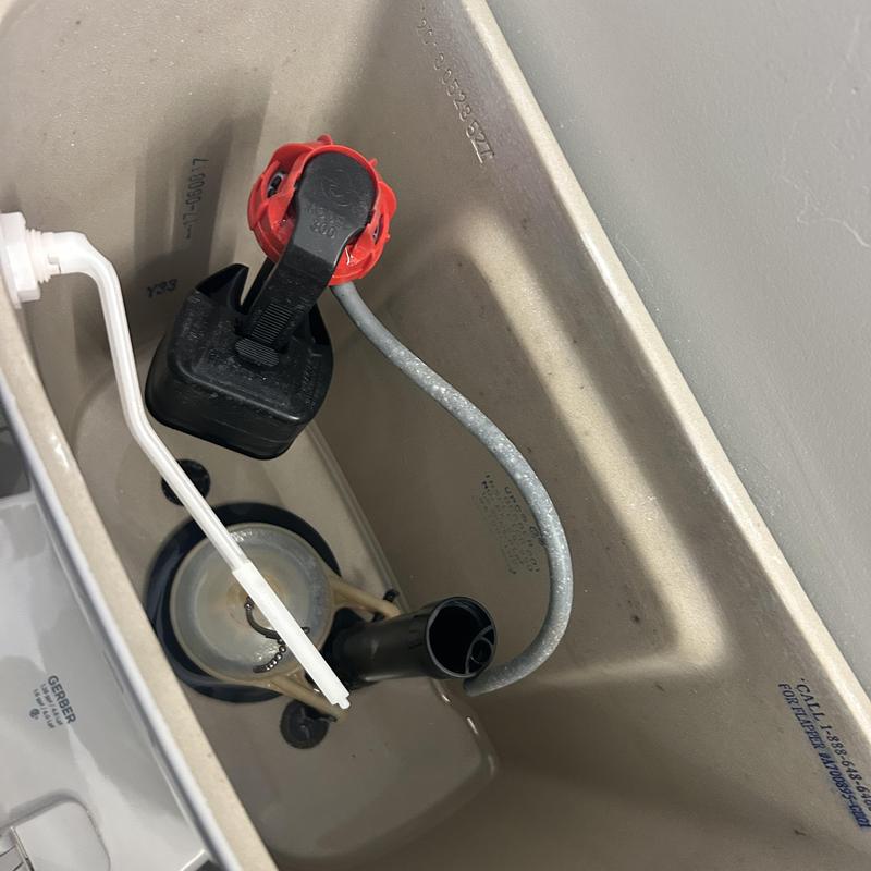 Toilet tank flapper and fill valve components inside tank