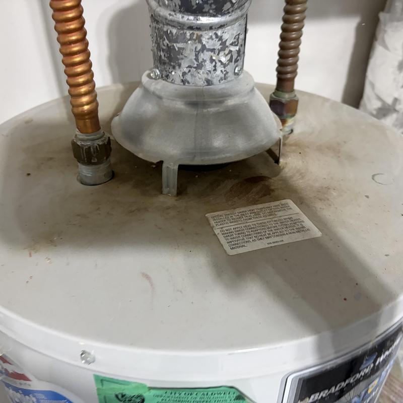Water heater top with copper pipes and vent collar