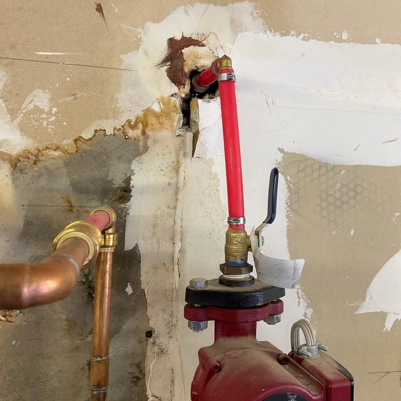 Circulating pump with red PEX piping and valve