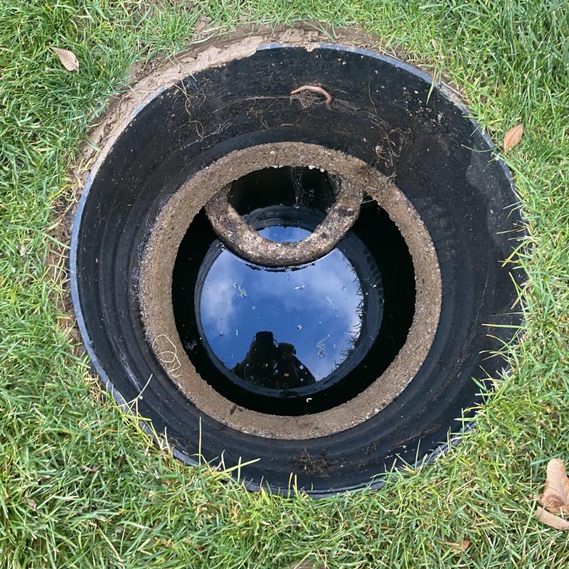 Septic tank riser and opening with water visible