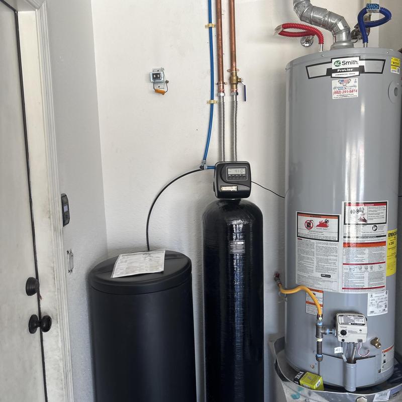 Water softener and water heater setup in utility room Water softener and water heater setup in utility room
