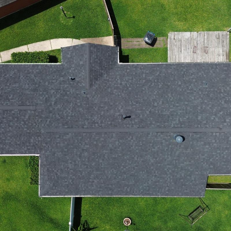 Owens Corning Onyx black shingle roof with gutters