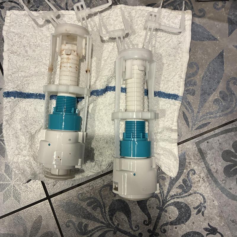 Kohler toilet flush valves on towel and tile floor Kohler toilet flush valves on towel and tile floor