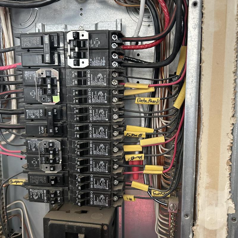 Garage electrical circuit breaker panel with wiring tags