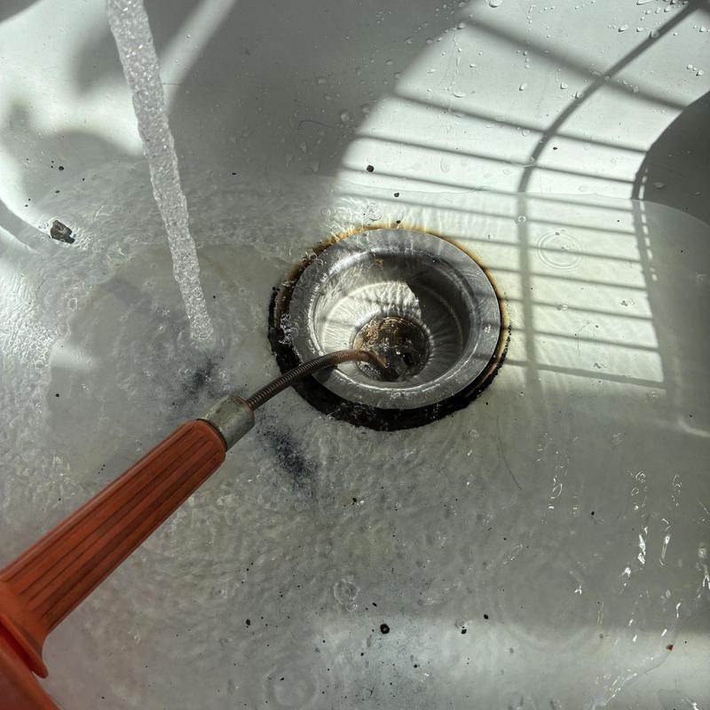 Kitchen sink drain cabling and flushing in progress Kitchen sink drain cabling and flushing in progress